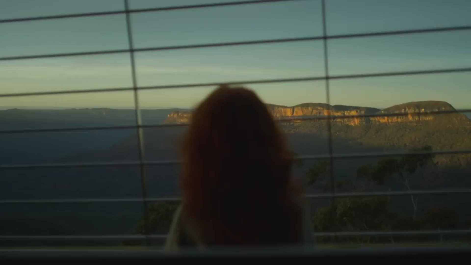 Woman looking out from the Scenic Skyway during sunset